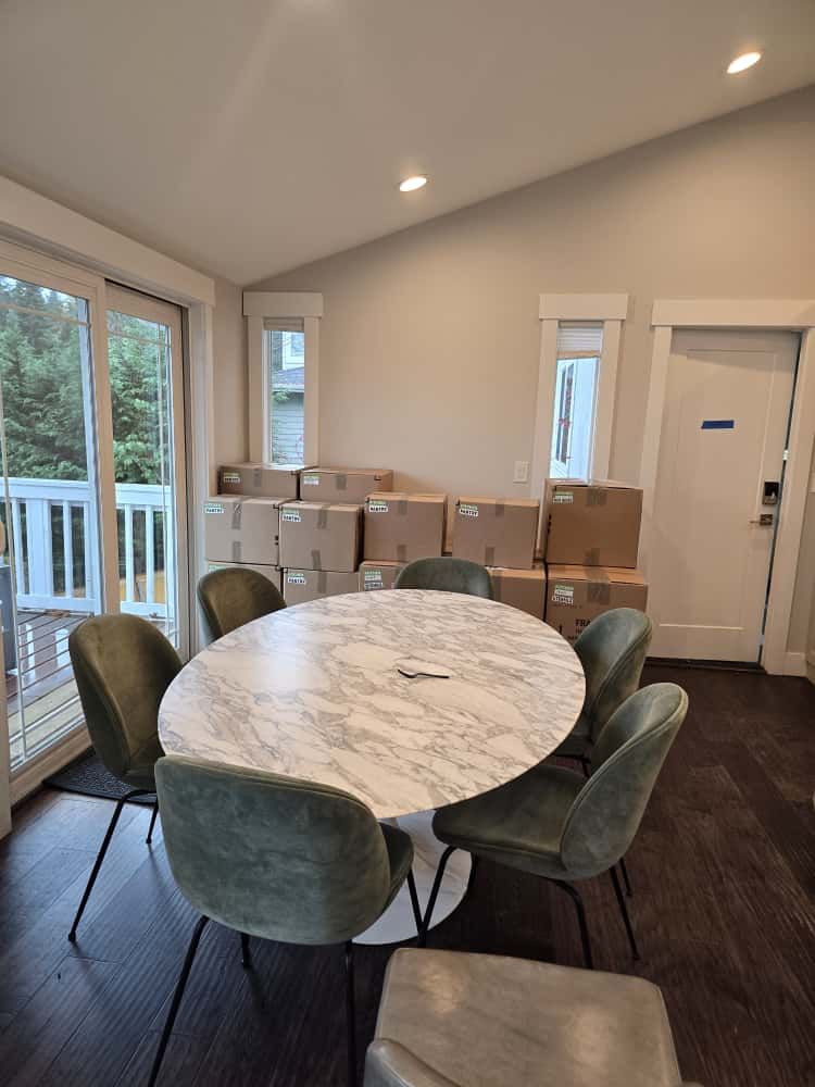 Neatly labeled moving boxes organized in upscale Seattle dining room